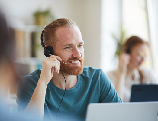 mature-bearded-man-headphones-working-table-with-laptop-office